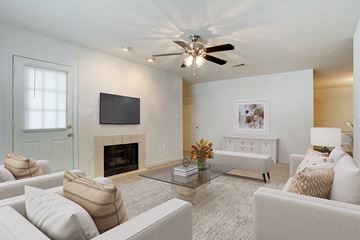Pearl apartment for rent - a living room with a ceiling fan and a television