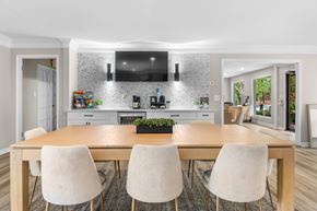 Hoover apartment for rent - A modern kitchen with a wooden dining table and chairs. at Riverchase Landing Apartments, Hoover, Alabama