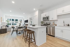 East Hanover apartment for rent - A modern kitchen with white cabinets and a wooden island.