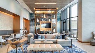Dallas apartment for rent - A modern living room with a large sectional sofa and a coffee table.