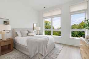 Fair Lawn apartment for rent - A bedroom with a large bed and a view of trees outside the window.