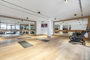 Fair Lawn apartment for rent - A gym with a wooden floor and a mirror on the wall.