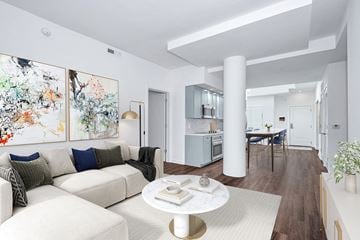Washington apartment for rent - A modern living room with a white couch and a coffee table.