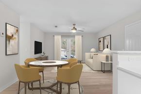 Pearl apartment for rent - A modern dining room with a round table and yellow chairs.