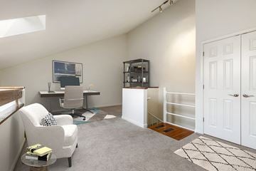 Columbia apartment for rent - A living room with a grey carpet and a white chair.