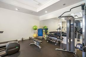 Slidell apartment for rent - A well-equipped gym with various exercise machines and equipment.