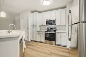 Norfolk apartment for rent - A kitchen with white cabinets and stainless steel appliances.at River House Apartments, Virginia, 23504