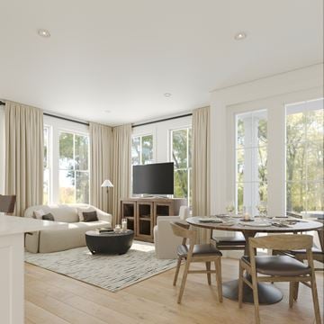 Colts Neck apartment for rent - A modern living room with a white sofa, a black coffee table, a TV, and a dining table with chairs.