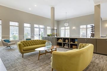 Lafayette apartment for rent - a living room with couches and a coffee table in front of a kitchen