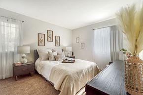 Plainsboro Township apartment for rent - a bedroom with a large bed and a wooden table at Quail Ridge, New Jersey