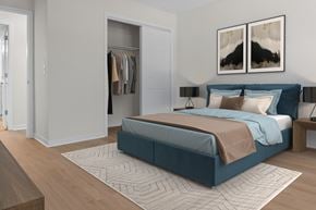 Flowood apartment for rent - A bedroom with a large bed and a wardrobe. at Reflection Pointe, Flowood, MS, 39232