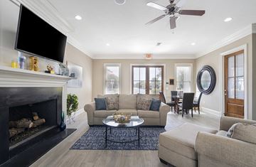 Shreveport apartment for rent - a living room with a couch and a tv and a fireplace