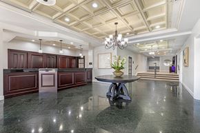 Alexandria apartment for rent - A spacious kitchen with dark wood cabinets and a marble countertop. at Seminary Towers, Alexandria, 22304