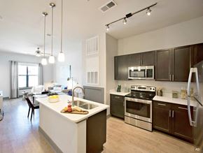 Baton Rouge apartment for rent - a kitchen with a large island and stainless steel appliances at The Addison, Baton Rouge, 70836
