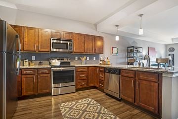 Montgomery apartment for rent - a kitchen with wooden cabinets and stainless steel appliances