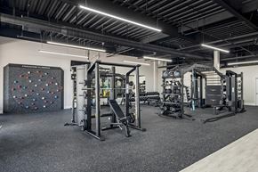 Bossier City apartment for rent - a gym with weights machines and a rock wall at Villaggio Apartments, Bossier City, LA