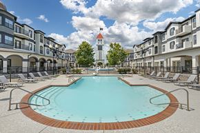 Bossier City apartment for rent - our apartments have a large pool with a church tower in the background at Villaggio Apartments, Louisiana, 71111