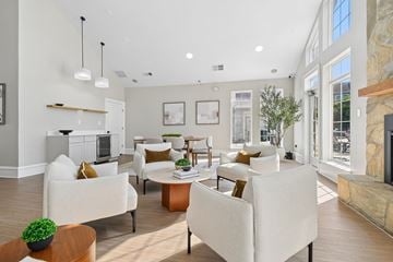 Frederick apartment for rent - A living room with white furniture and a fireplace.