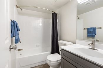 A bathroom with a sink toilet and bathtub