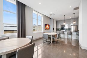 Jersey City apartment for rent - A modern dining room with a large table and chairs.