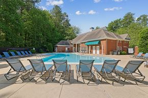 Williamsburg apartment for rent - A pool surrounded by lawn chairs in front of a house.