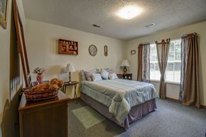 Atlanta apartment for rent - a bedroom with a bed and a dresser and a window