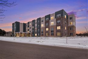 Grand Rapids apartment for rent - A large apartment building with multiple floors and balconies is shown in the image.