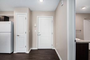 Grand Rapids apartment for rent - a renovated kitchen with white doors and a refrigerator