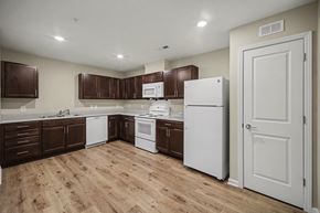 Cherryville apartment for rent - A kitchen with brown cabinets and white appliances.