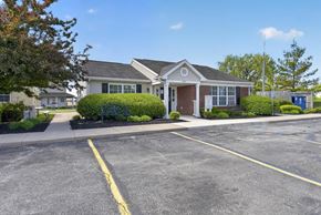 Walbridge apartment for rent - A building with a parking lot in front of it.
