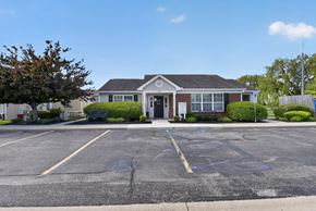 Walbridge apartment for rent - A parking lot in front of a building with a clear blue sky.