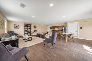 Pontiac apartment for rent - A living room with a grey couch and a brown table.