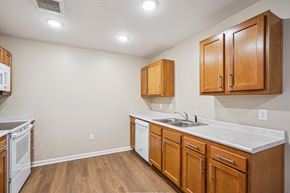Des Moines apartment for rent - A kitchen with wooden cabinets and a white countertop.