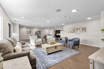 Wilton apartment for rent - a living room with a couch and chairs and a table
