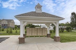 Shippensburg apartment for rent - A gazebo with a clock tower is surrounded by a brick wall and a grassy area.