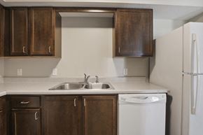 Columbus apartment for rent - a kitchen with wooden cabinets and a white dishwasher