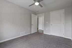 Columbus apartment for rent - a bedroom with a ceiling fan and a door to a hallway
