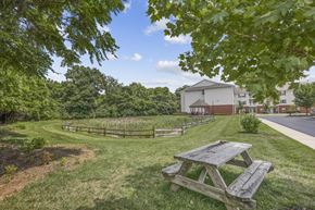 Columbus apartment for rent - a picnic table in a park with a building in the background