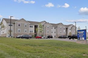 Ashland apartment for rent - a large apartment building with cars parked in front of it
