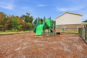 Madison apartment for rent - A playground with a green slide and a red slide.