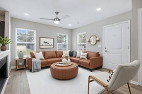 Madison apartment for rent - A living room with a brown sofa, a round coffee table, and a white chair.