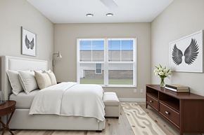 Madison apartment for rent - A bedroom with a large bed and a window overlooking a lawn.