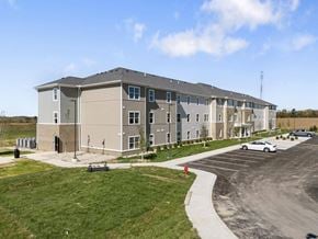 Carrollton apartment for rent - a large building with a car parked in front of it