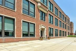 Circleville apartment for rent - a large brick building with large windows and a sidewalk