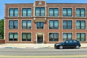 Circleville apartment for rent - a car parked in front of a brick building