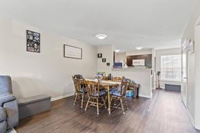 Cedar Rapids apartment for rent - a dining area with a table and chairs and a kitchen in the background