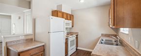 Pontiac apartment for rent - a kitchen with a white refrigerator freezer next to a stove top oven