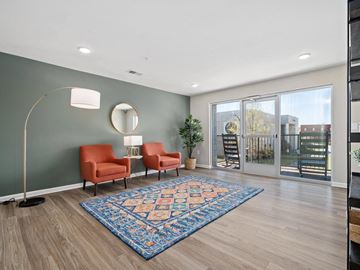 Rocky Mount apartment for rent - a living room with two orange chairs and a rug   and a sliding glass