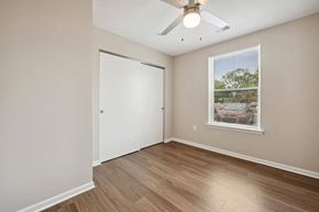 East Lansing apartment for rent - a bedroom with hardwood floors and a ceiling fan
