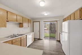 St. Clairsville apartment for rent - A kitchen with wooden cabinets and a white refrigerator.